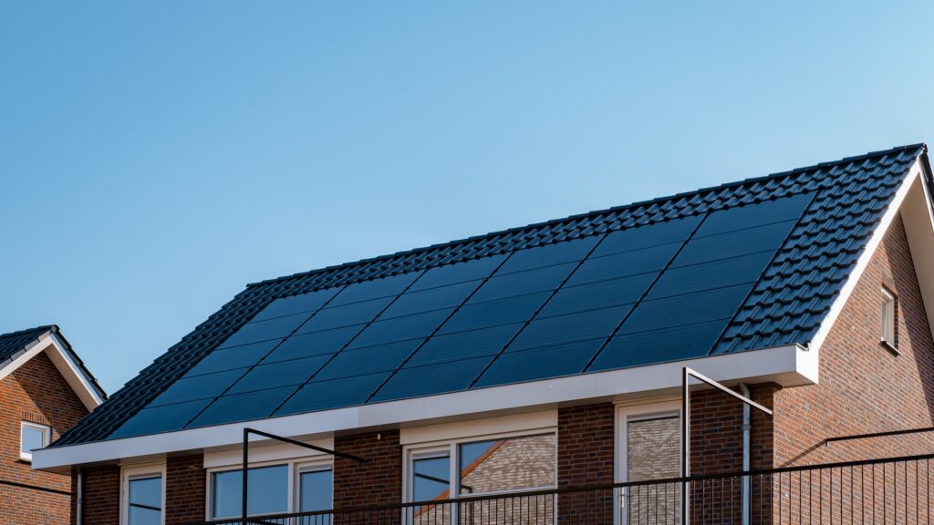 Newly build houses with solar panels attached on roof against a sunny sky Close up of solar pannel